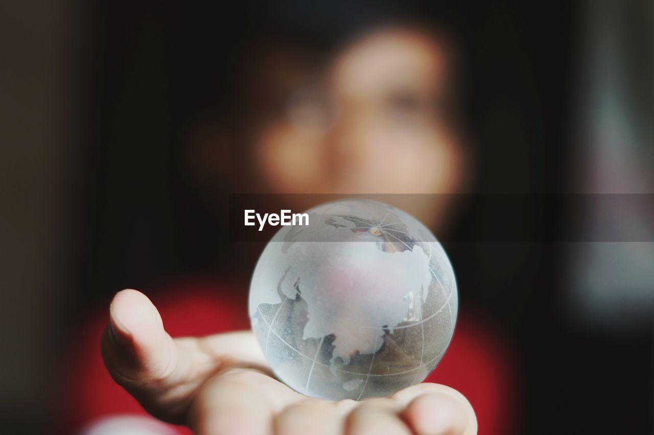Woman holding crystal globe