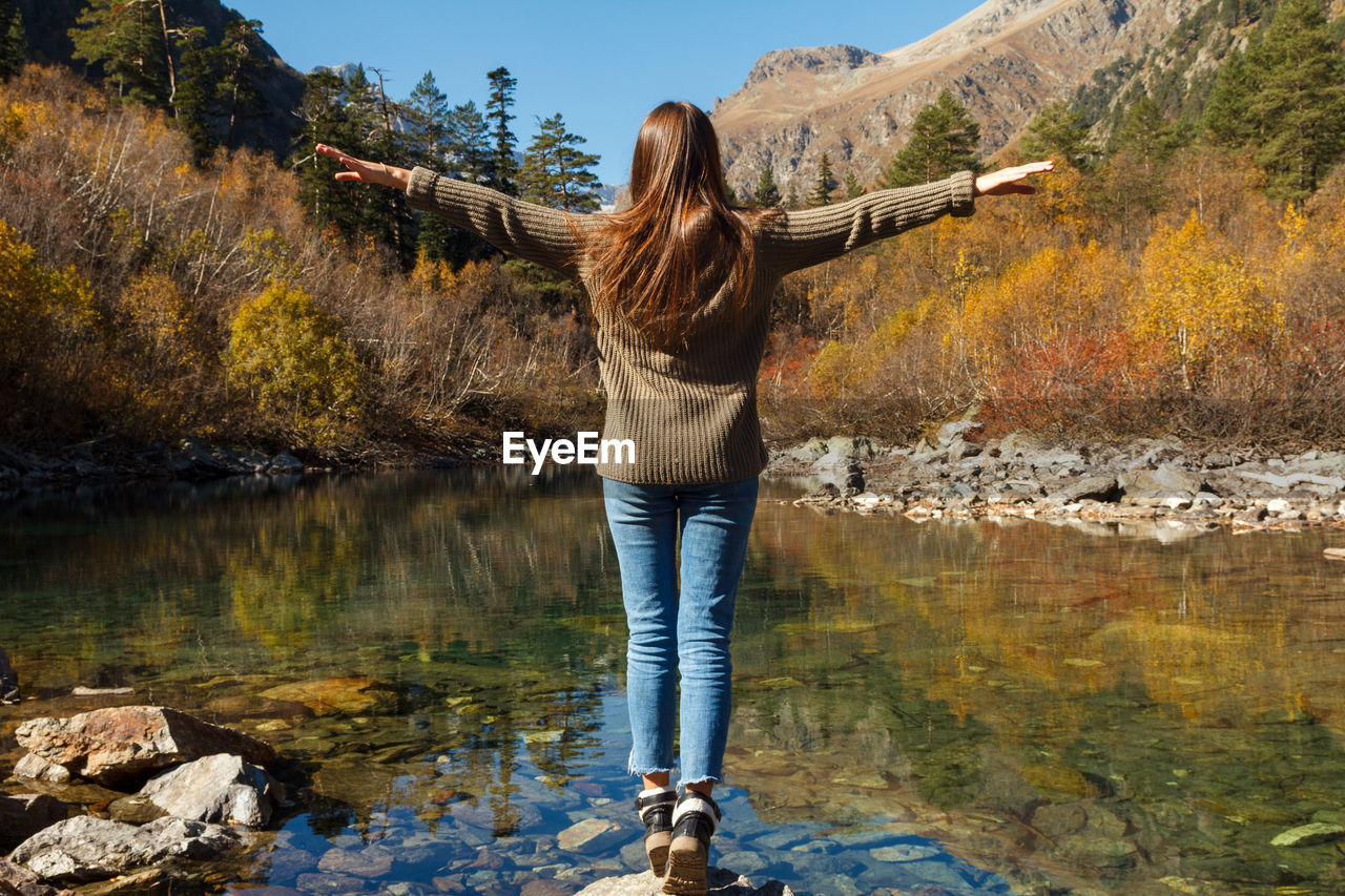 Nice girl traveler on a mountain lake