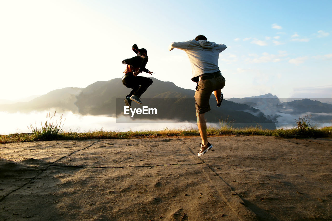 People jumping into the sea of clouds at the ruins of takeda castle