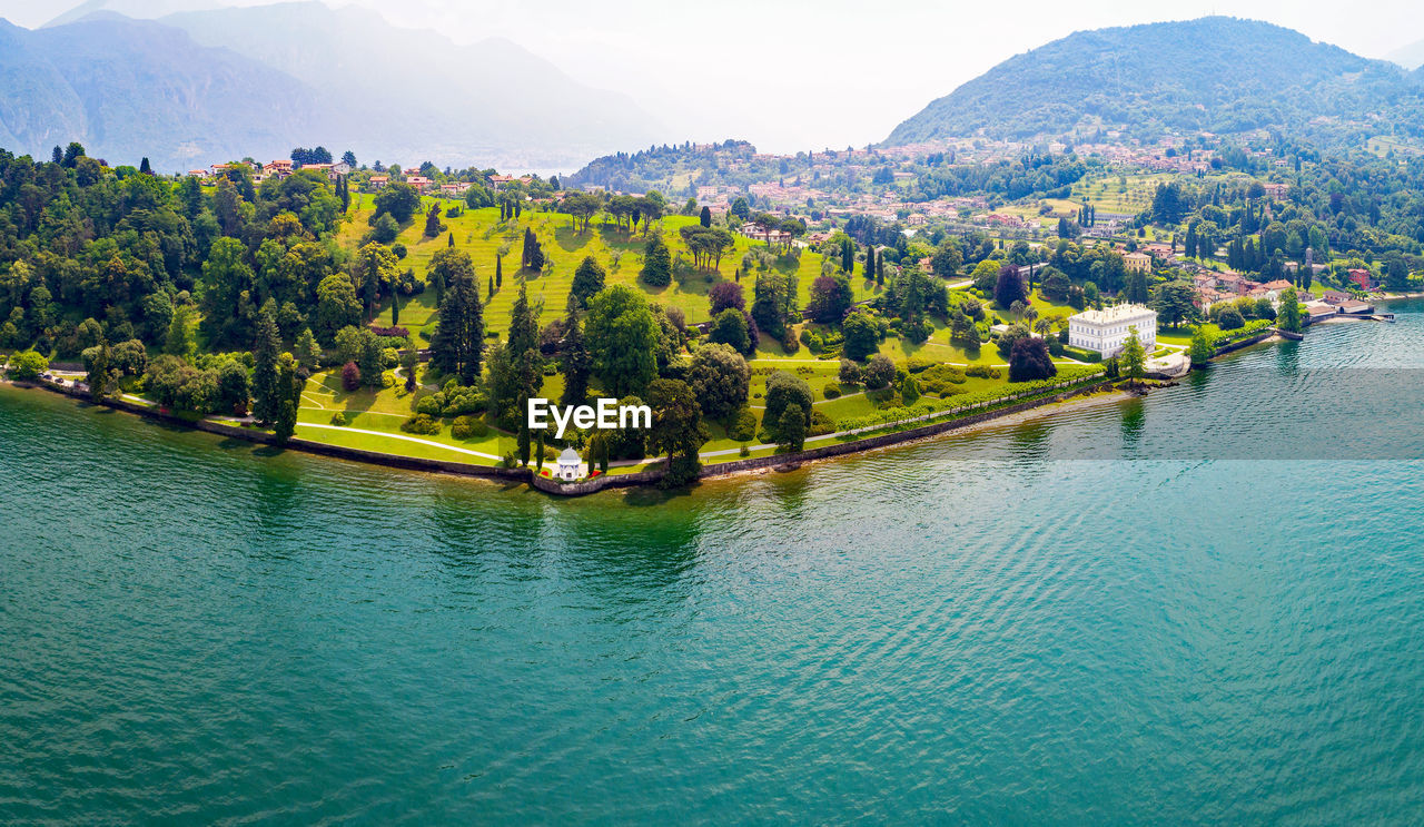 SCENIC VIEW OF LAKE BY TREE MOUNTAINS AGAINST SKY