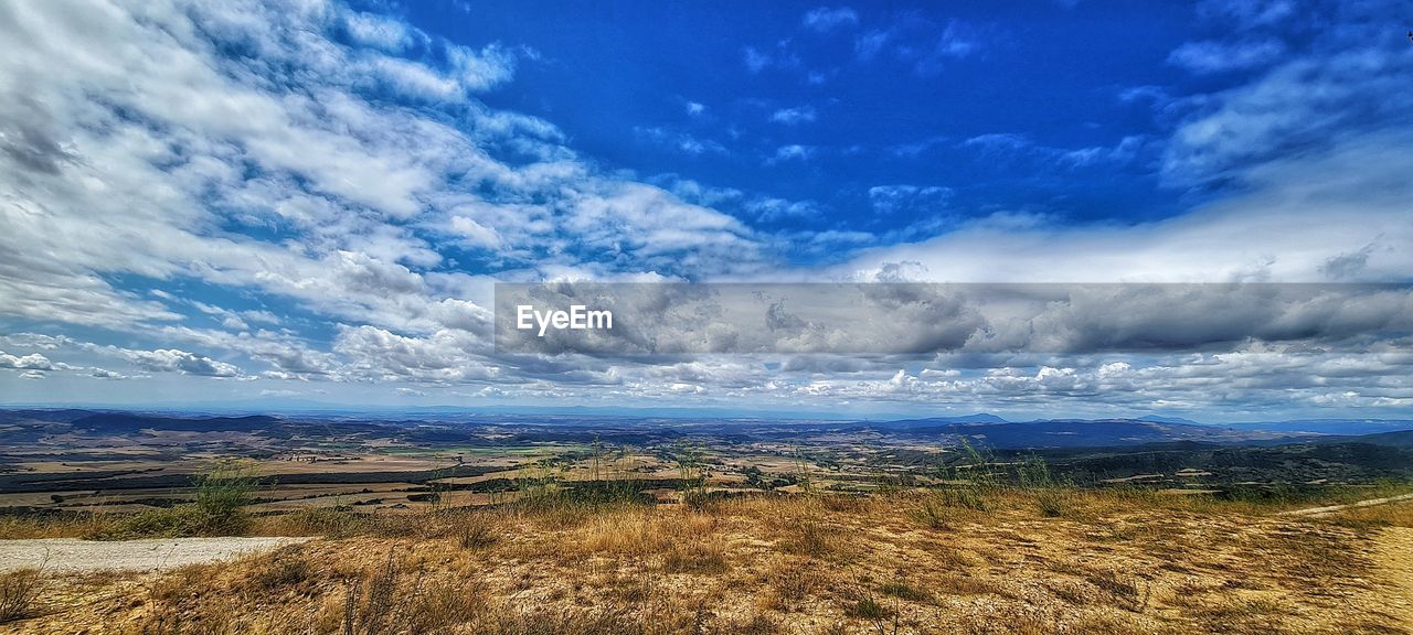 SCENIC VIEW OF LANDSCAPE AGAINST BLUE SKY