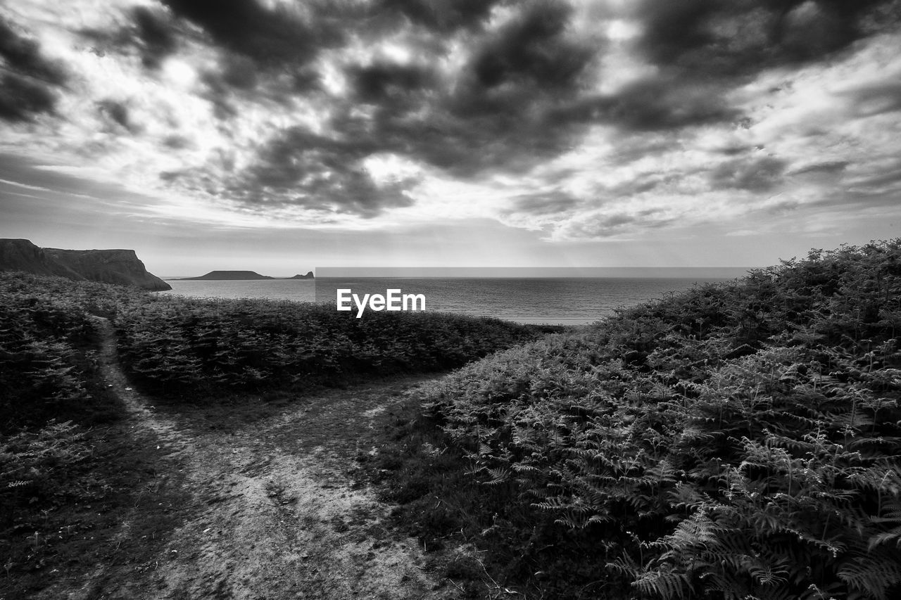 View of beach against cloudy sky