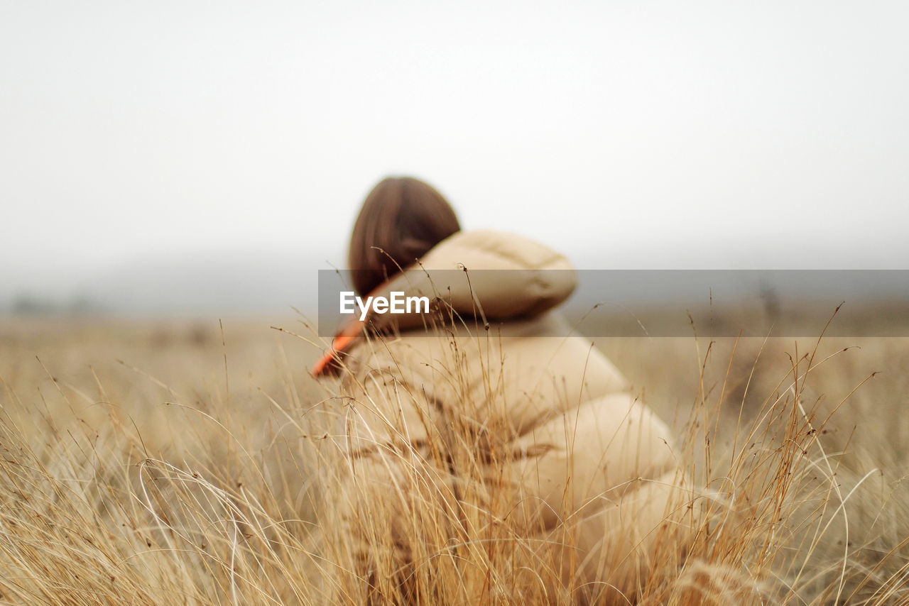 Unrecognizable female hands in autumn grass