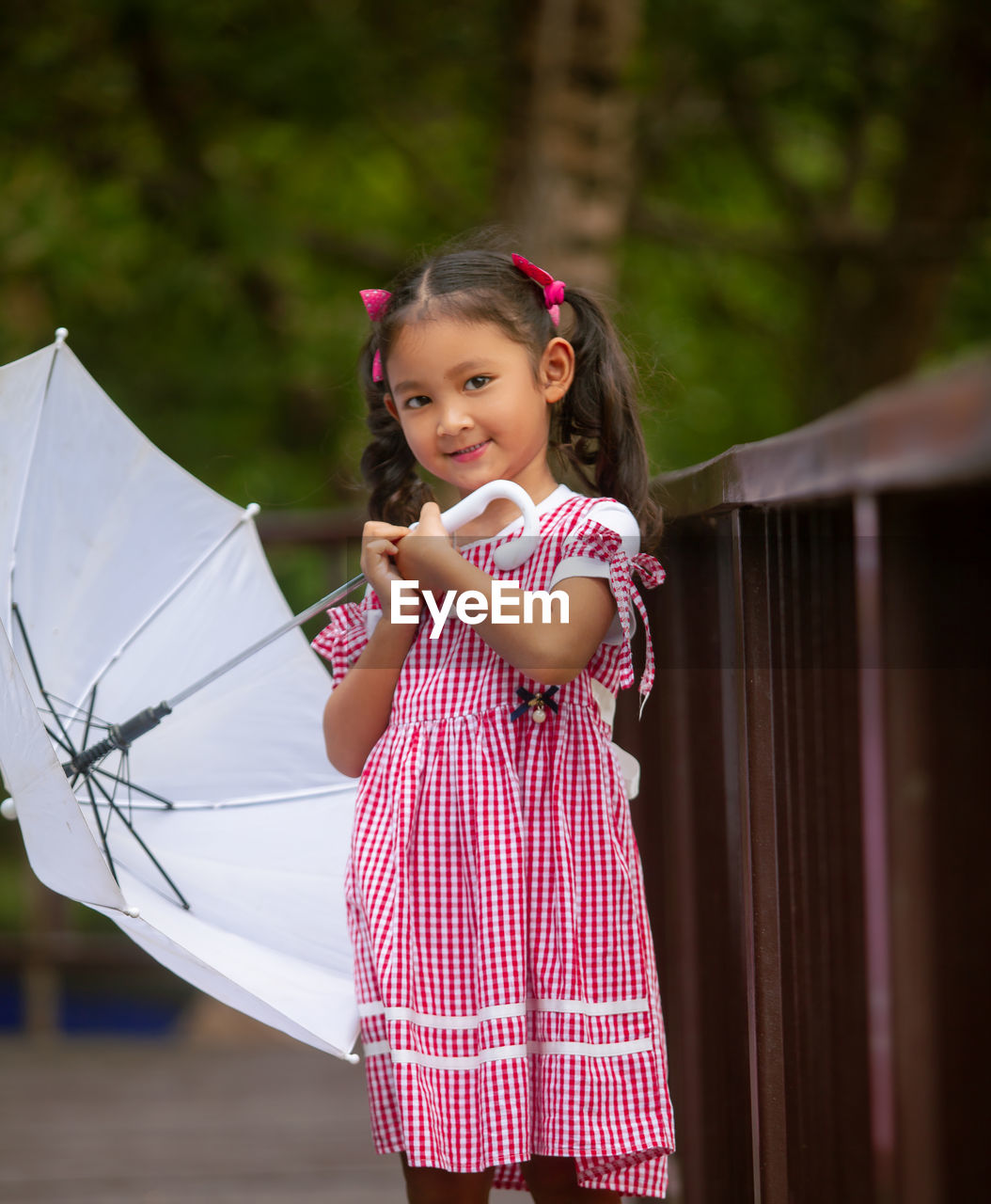 Portrait of cute girl holding umbrella