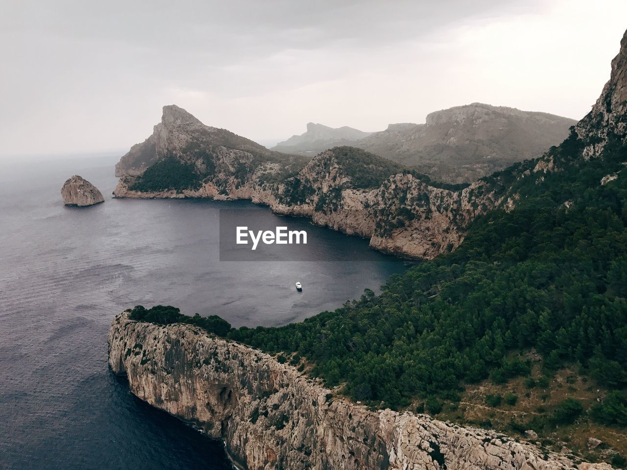 High angle view of sea and mountains against sky