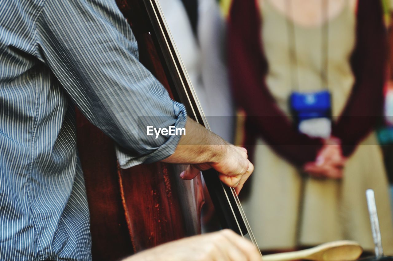 Close-up of man playing cello 