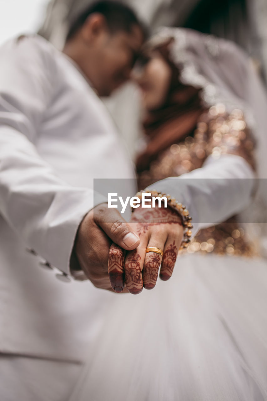 Bride and bridegroom holding hands during wedding ceremony