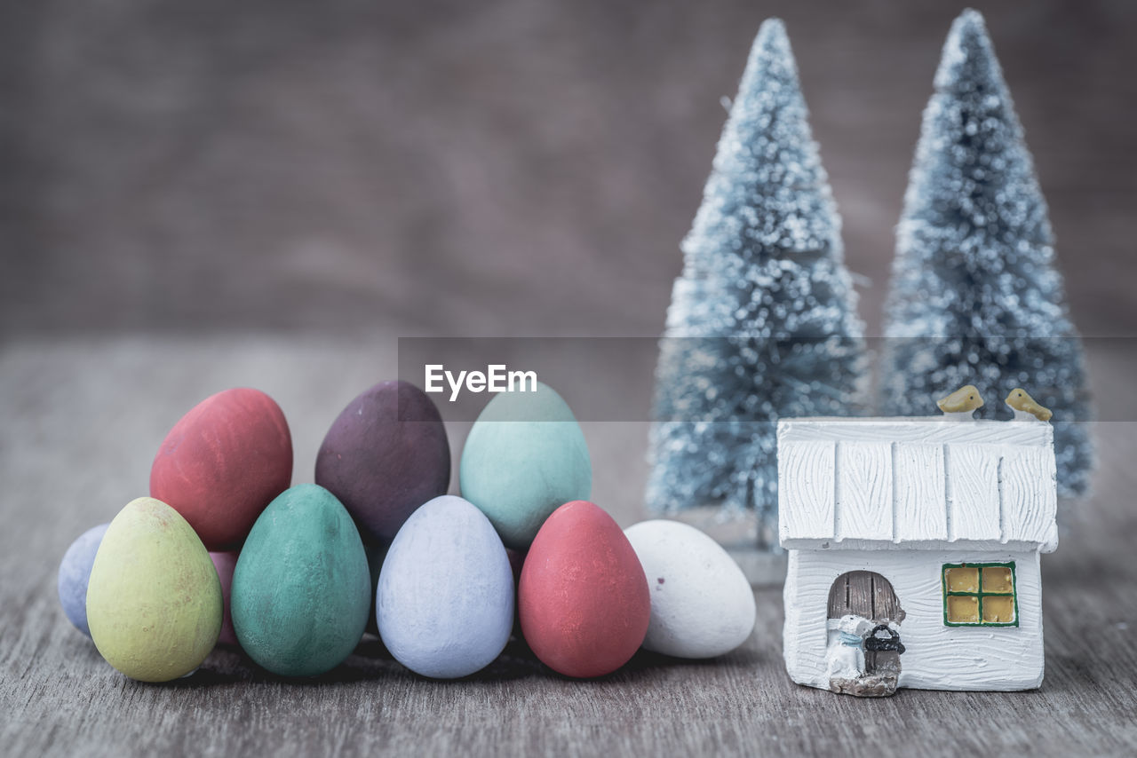 Close-up of colorful easter eggs by christmas decorations on table