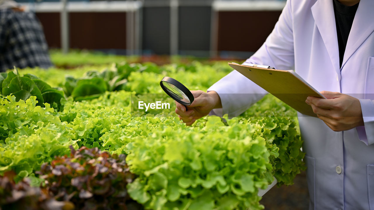 midsection of businessman using digital tablet