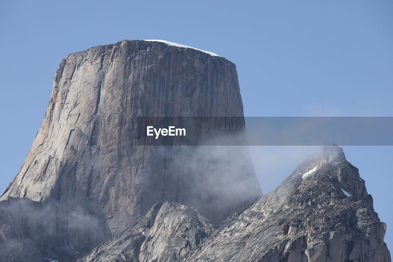 Cloud passes in front of iconic mountain, mount asgard, baffin island.