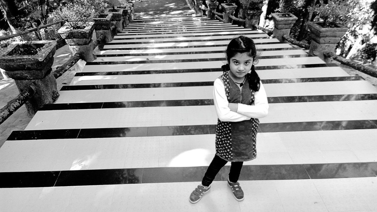 High angle view of cute girl standing on steps