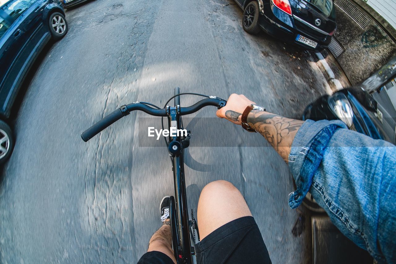 LOW SECTION OF PERSON RIDING BICYCLE ON ROAD