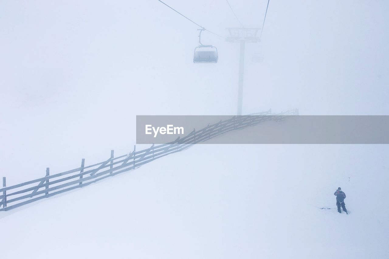 OVERHEAD CABLE CAR ON SNOW COVERED LANDSCAPE