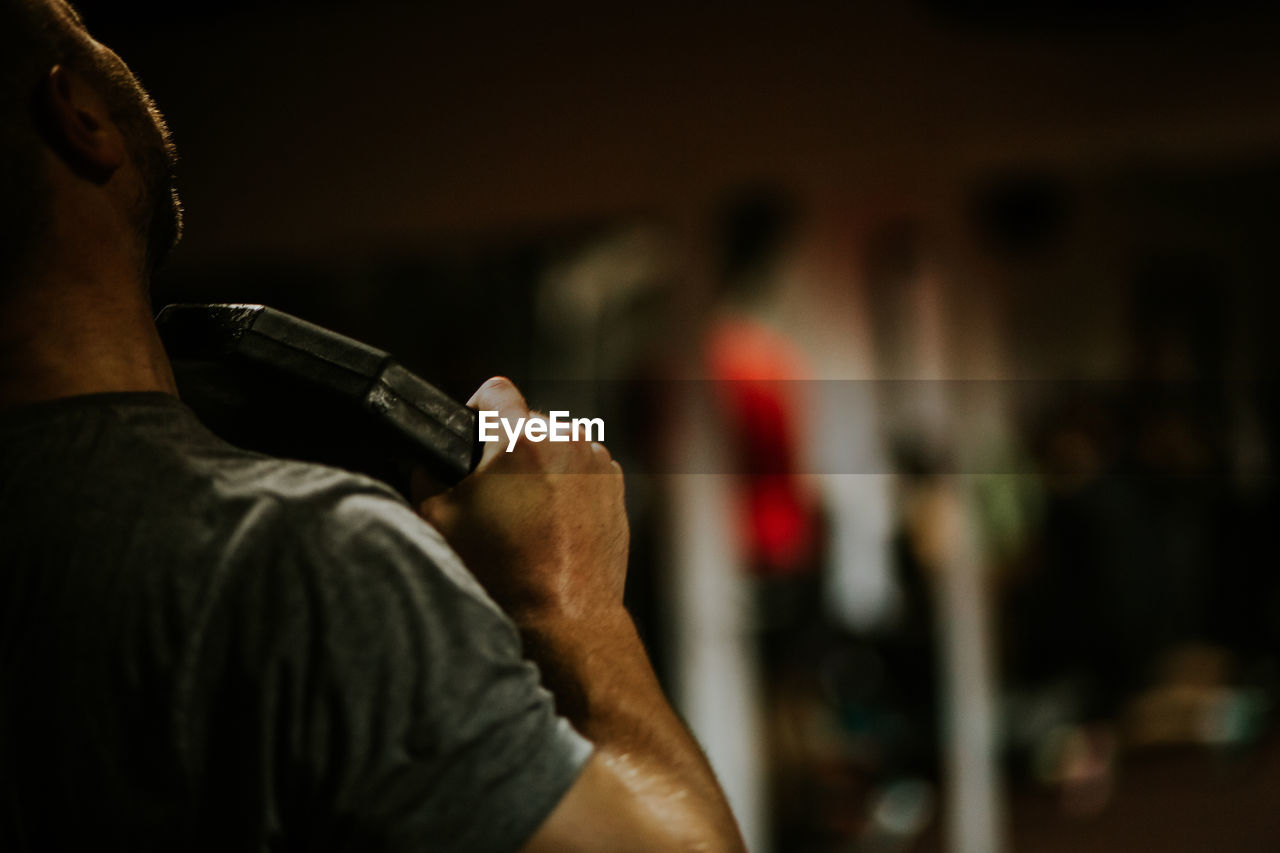 Midsection of man exercising at gym