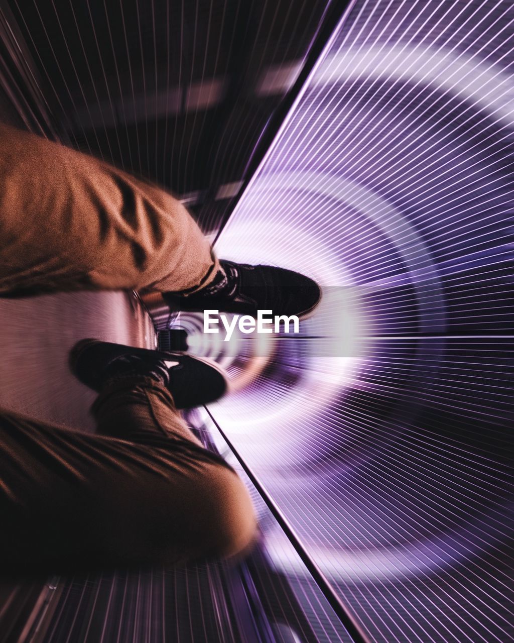 Low section of man on amusement park ride in tunnel