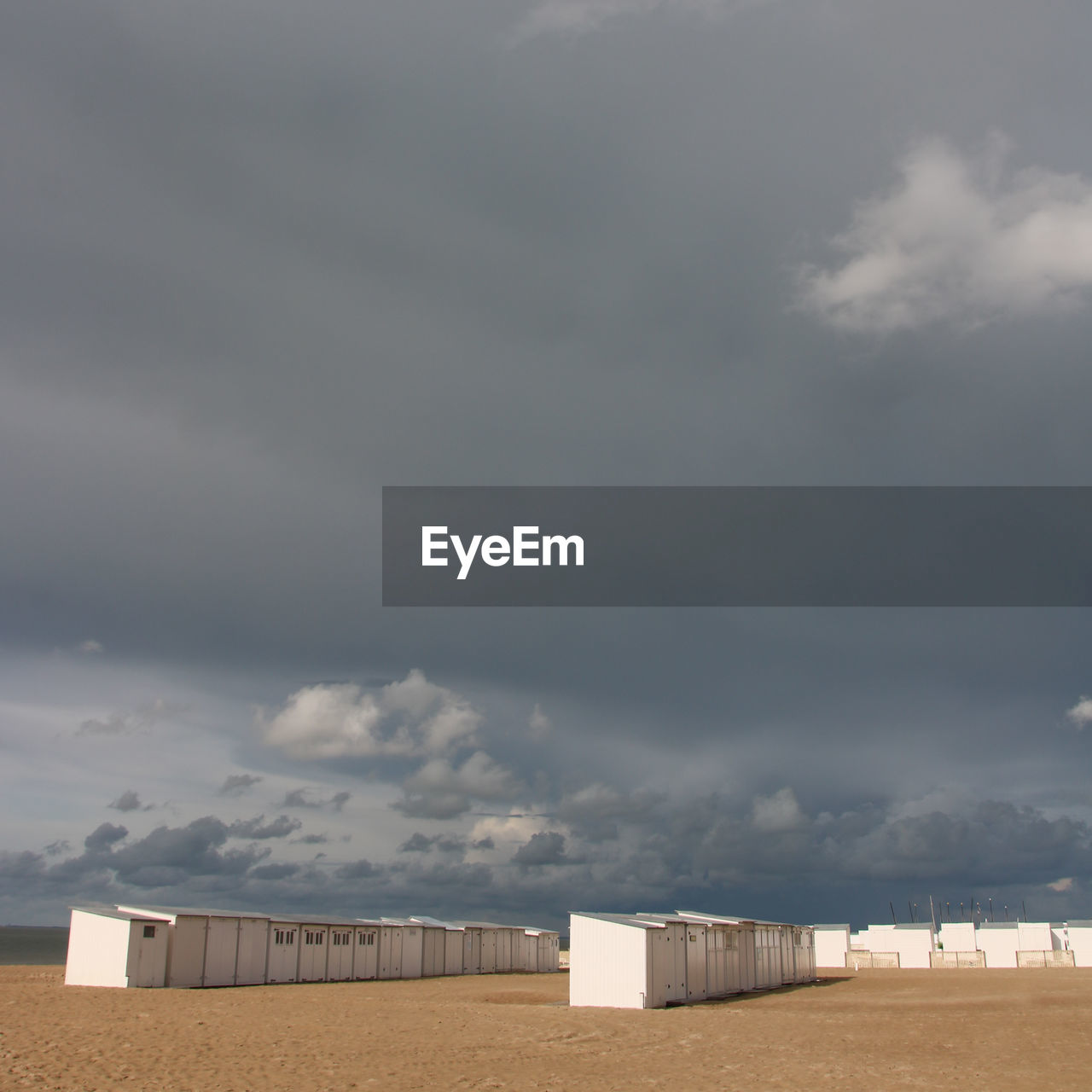cloud, sky, horizon, land, nature, architecture, built structure, environment, no people, building exterior, storm cloud, overcast, field, storm, building, hut, landscape, day, cloudscape, beach, outdoors, sand, wind, scenics - nature, dramatic sky, beauty in nature, sea