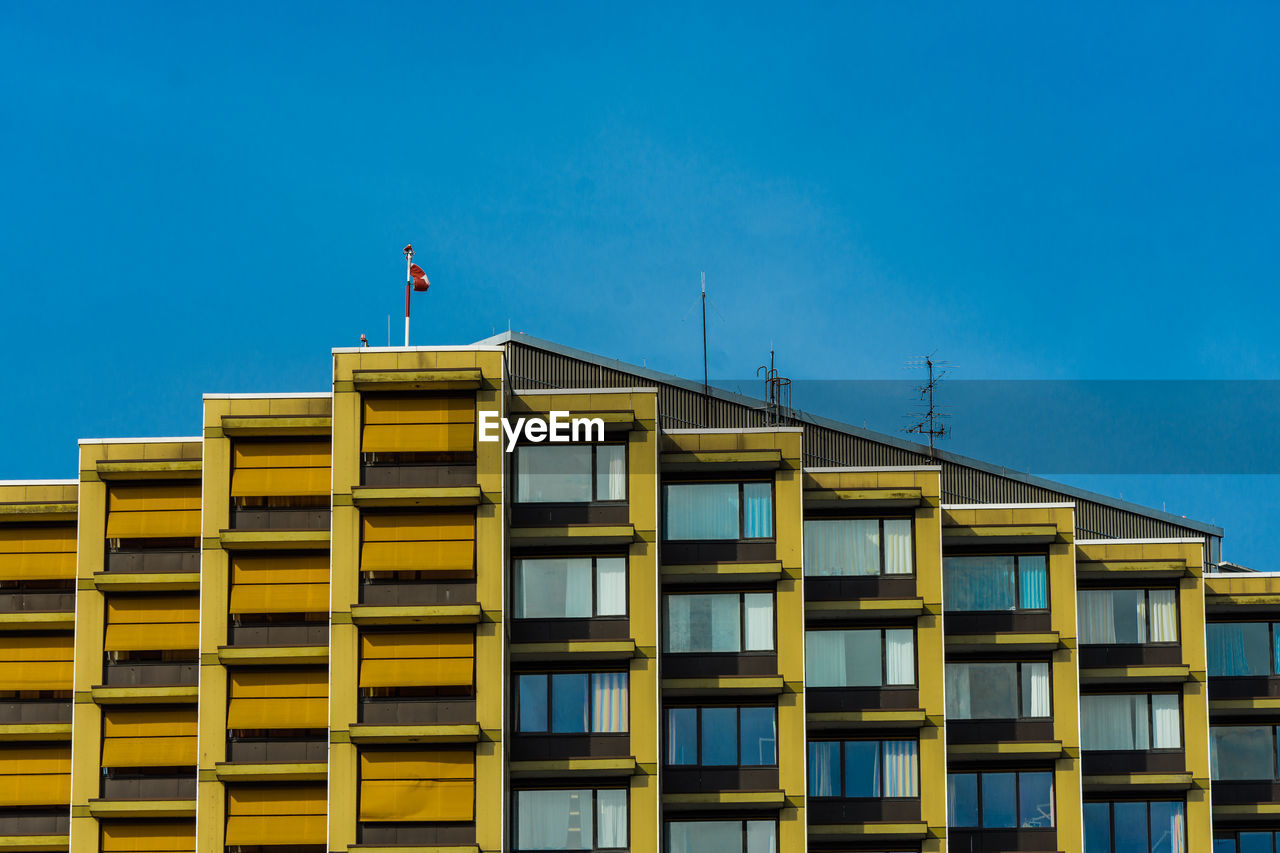 Low angle view of building against blue sky