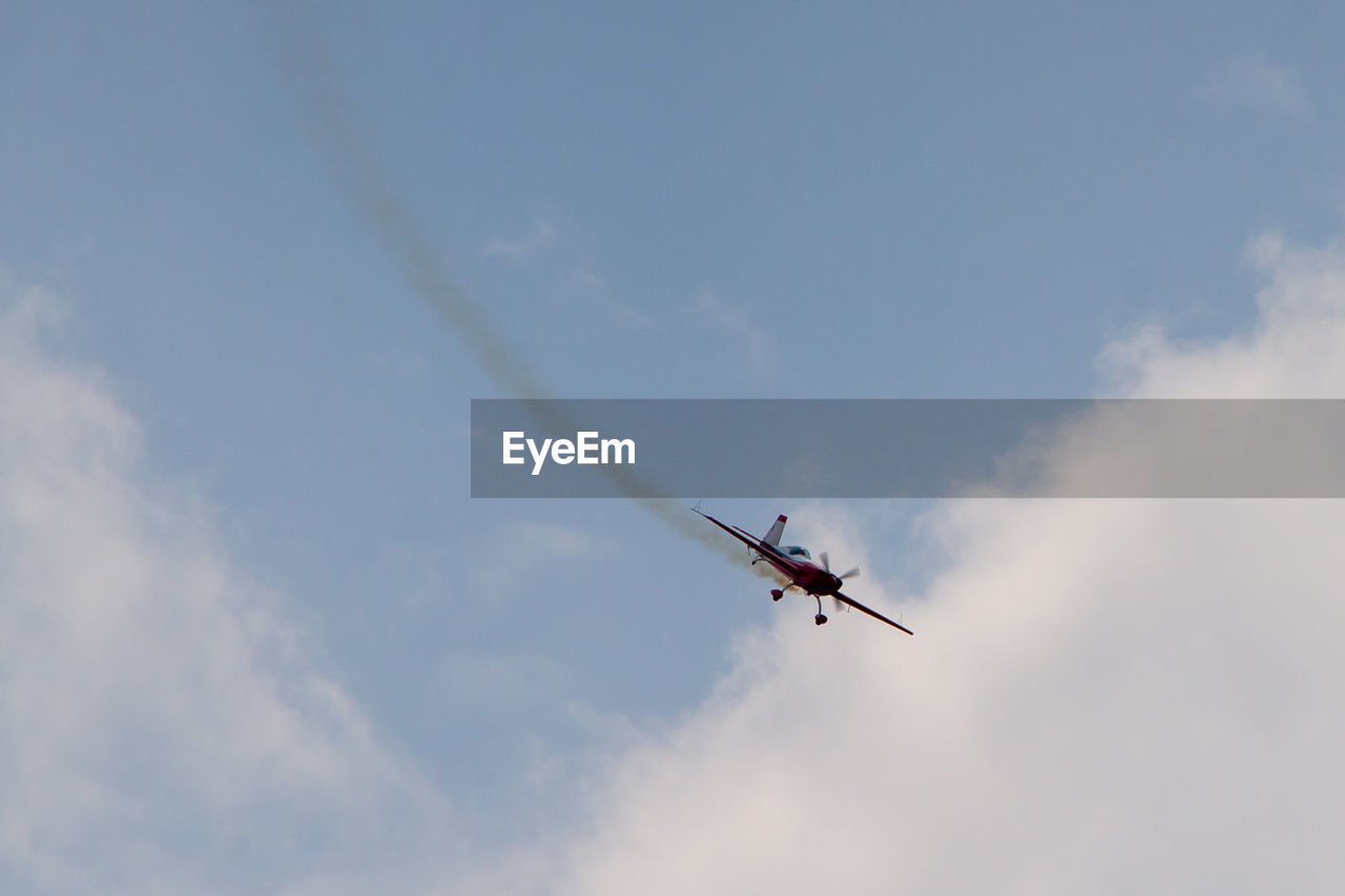 Low angle view of airplane flying in sky