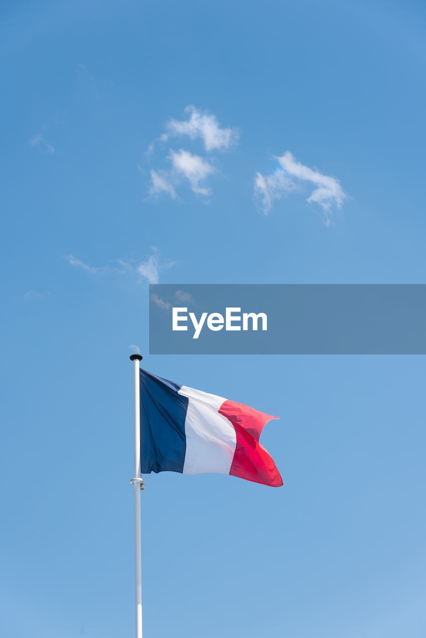 Low angle view of flag against blue sky. low angle view of french flag. the flag of france