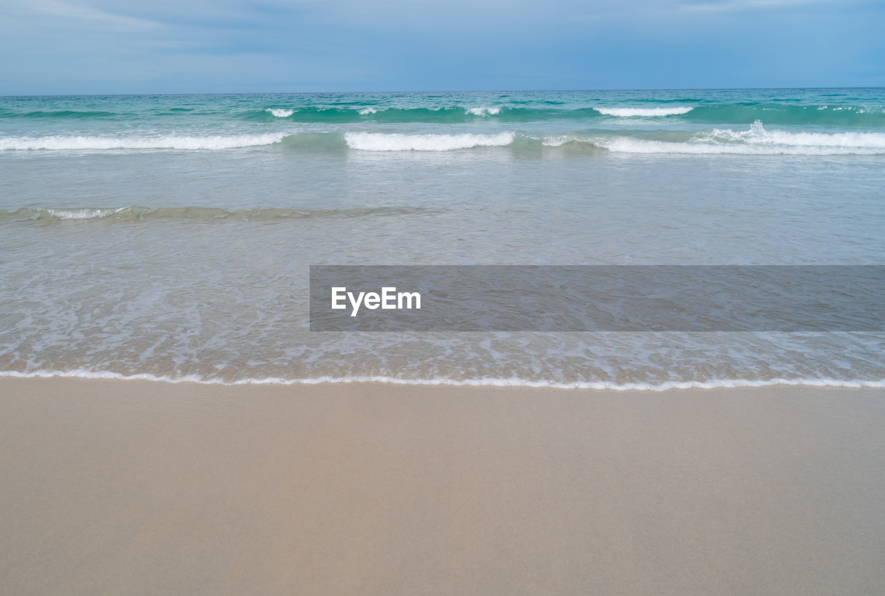 Tropical nature clean beach and white sand in summer with sun light blue sky.