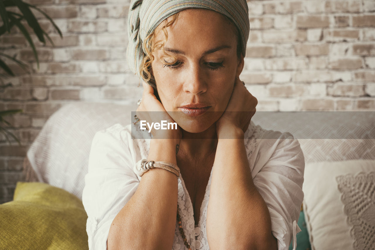 low angle view of woman sitting on sofa at home