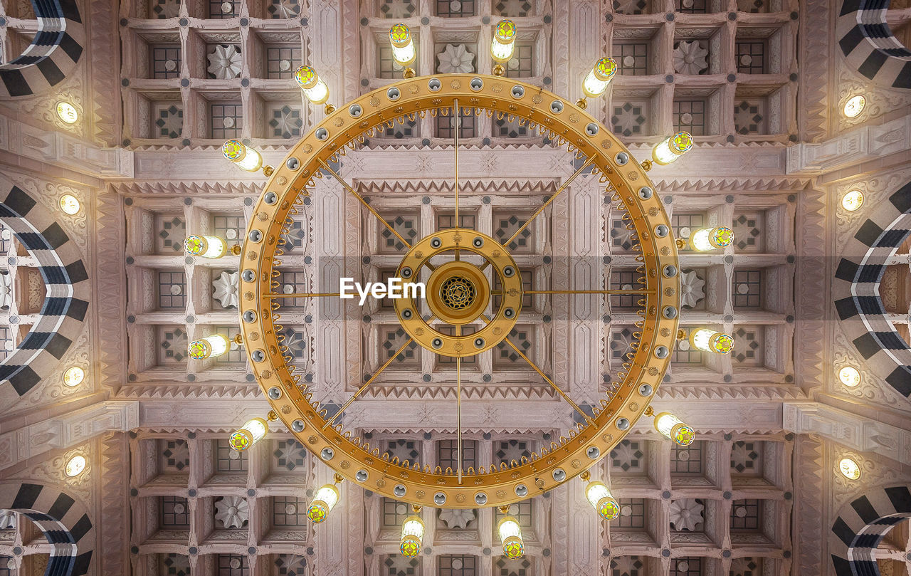 LOW ANGLE VIEW OF ILLUMINATED CLOCK TOWER