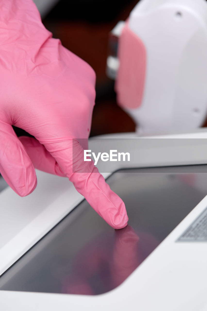 cropped hands of man using laptop on table