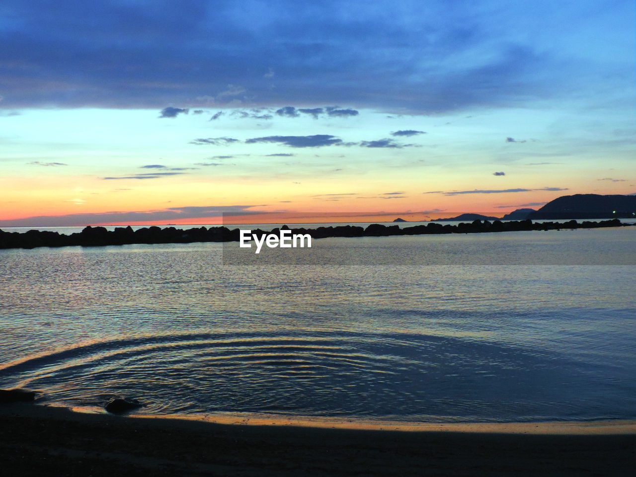 sunset, water, scenics, sea, nature, beauty in nature, sky, silhouette, tranquility, no people, outdoors, beach