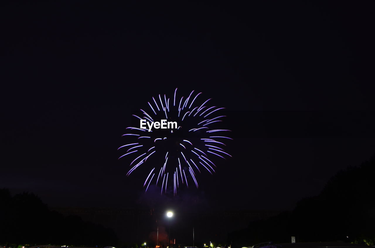 LOW ANGLE VIEW OF FIREWORKS EXPLODING