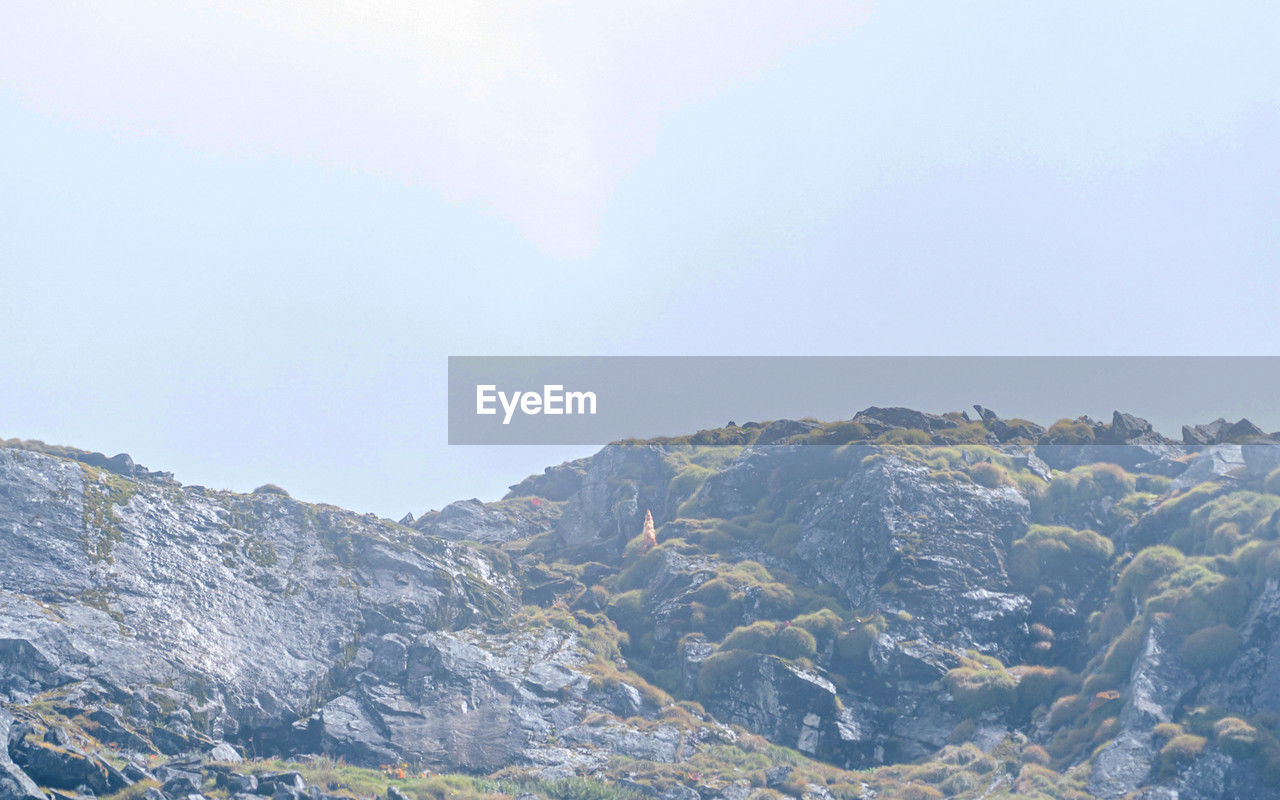 mountain, mountain range, environment, scenics - nature, beauty in nature, sky, landscape, nature, snow, no people, tranquility, cold temperature, winter, ridge, tranquil scene, land, day, travel destinations, travel, non-urban scene, outdoors, cloud, plateau, idyllic, blue, tourism, rock, plant, pinaceae, copy space, tree