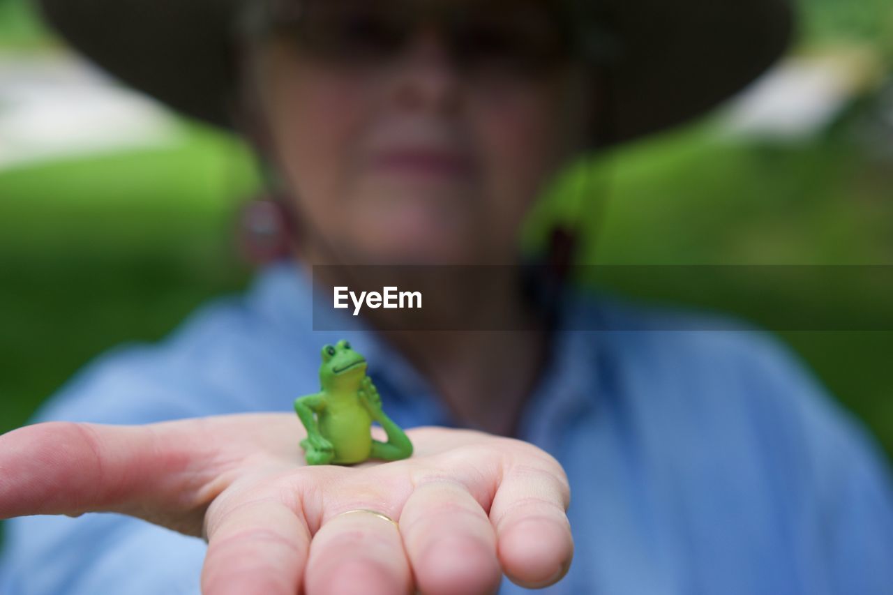 Close-up of man holding frog