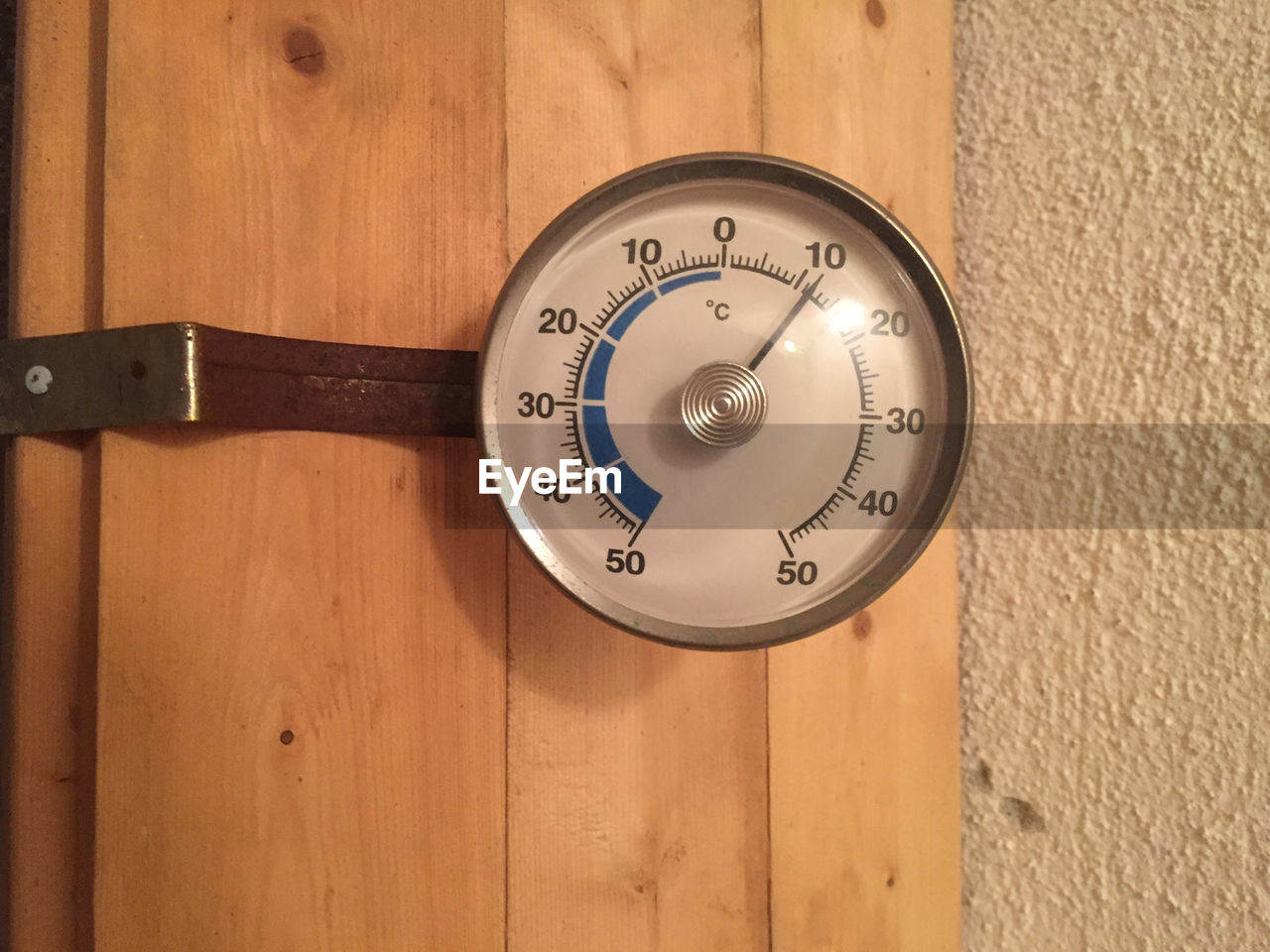 Celsius thermometer on wooden wall