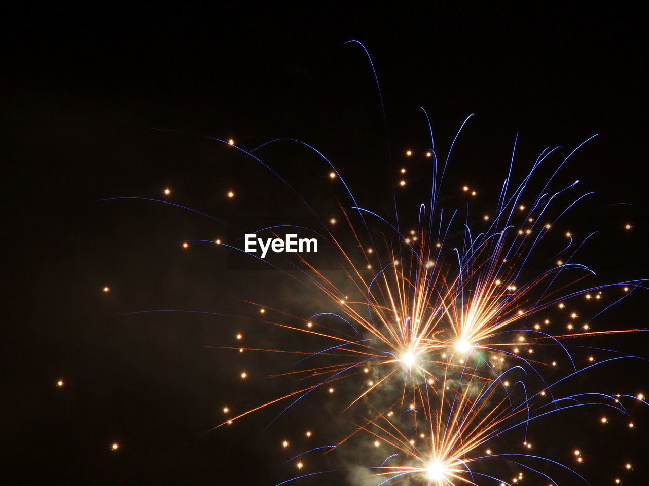 LOW ANGLE VIEW OF FIREWORK DISPLAY IN SKY AT NIGHT