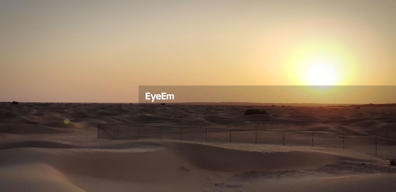SCENIC VIEW OF DESERT AT SUNSET
