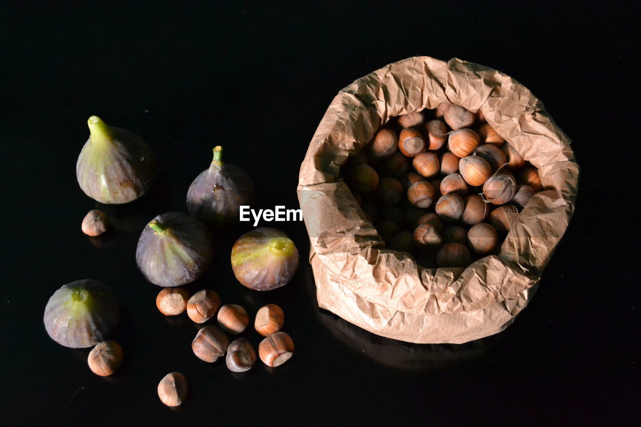 food and drink, food, black background, healthy eating, freshness, wellbeing, fruit, still life, studio shot, indoors, still life photography, nut, no people, produce, nut - food, nuts & seeds, macro photography, ingredient, large group of objects, vegetable, leaf, directly above, high angle view, plant, flower, table, organic, spice, close-up