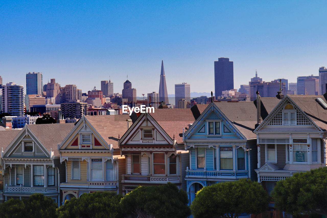 Modern buildings in city against clear blue sky - painted ladies - san francisco