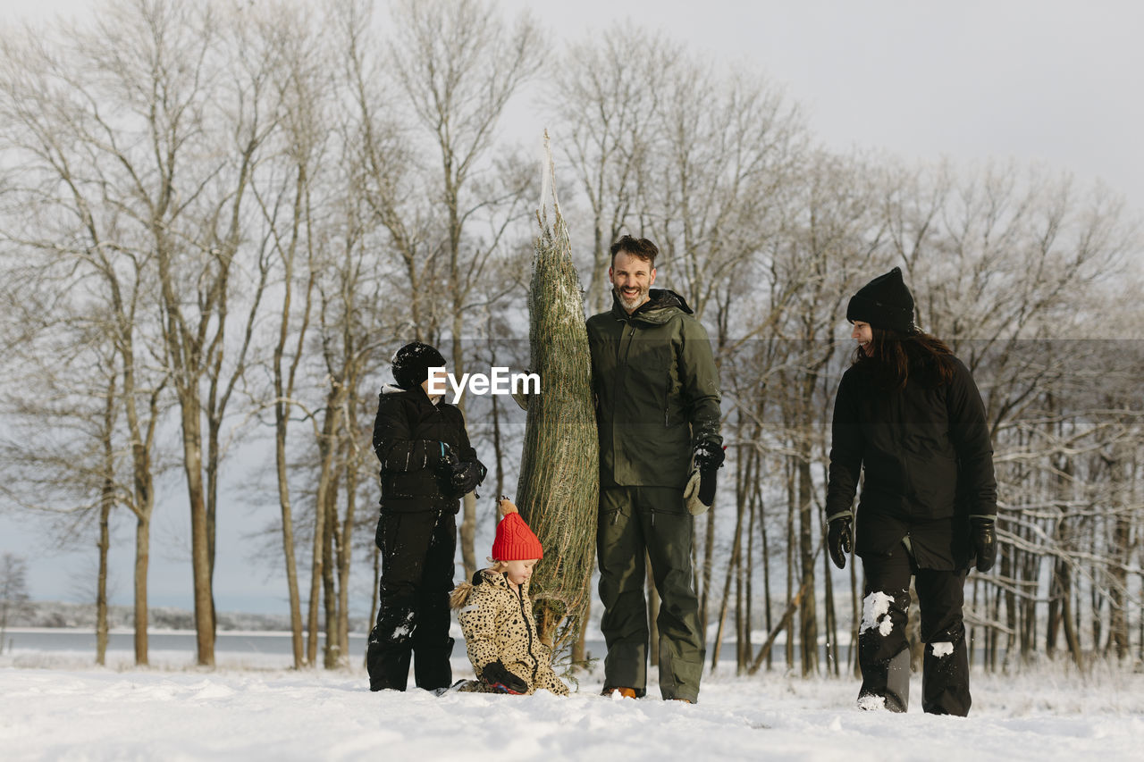 Family with christmas tree at winter