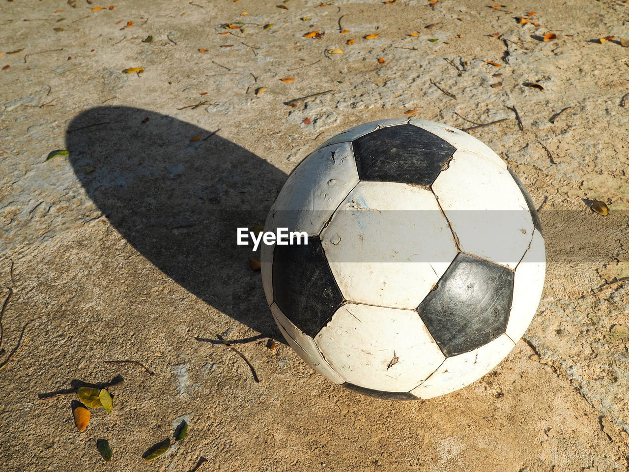 HIGH ANGLE VIEW OF SOCCER BALL ON STONE WALL