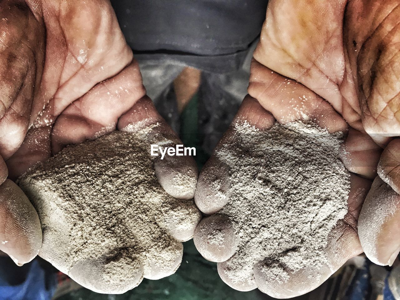 Close-up of hands holding cement