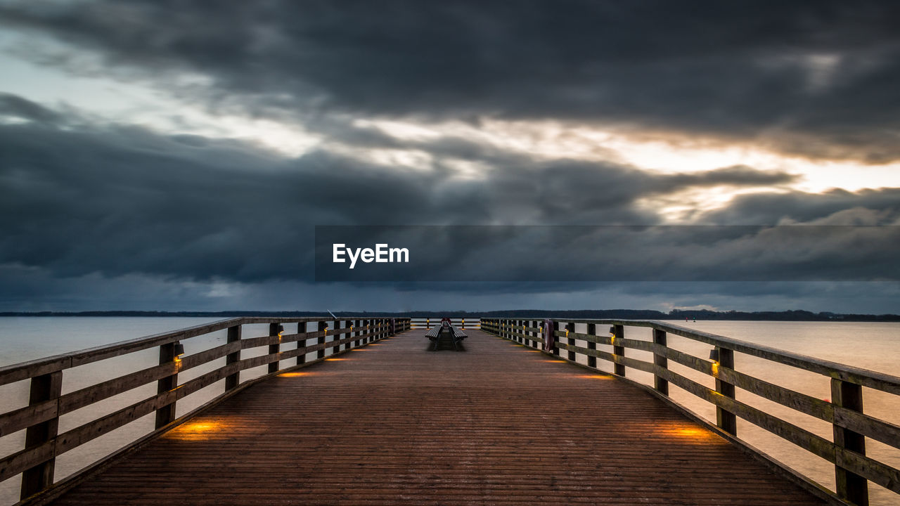 Pier over sea against sky