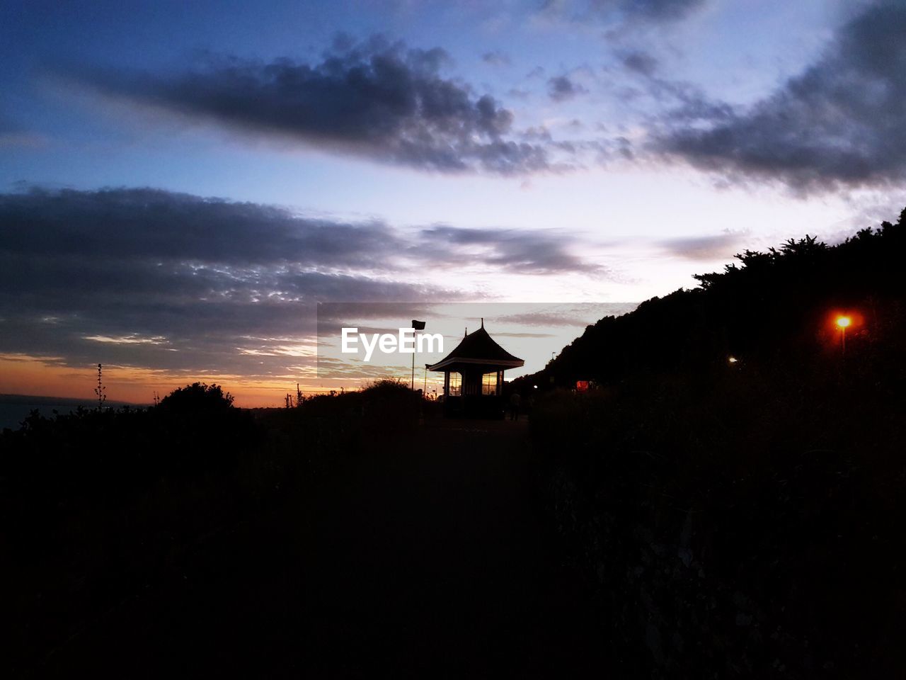 SILHOUETTE BUILDING AGAINST SKY DURING SUNSET