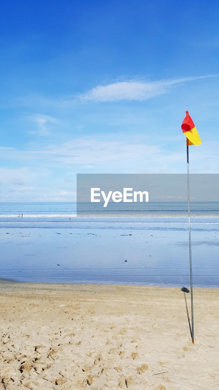 Scenic view of beach against cloudy sky