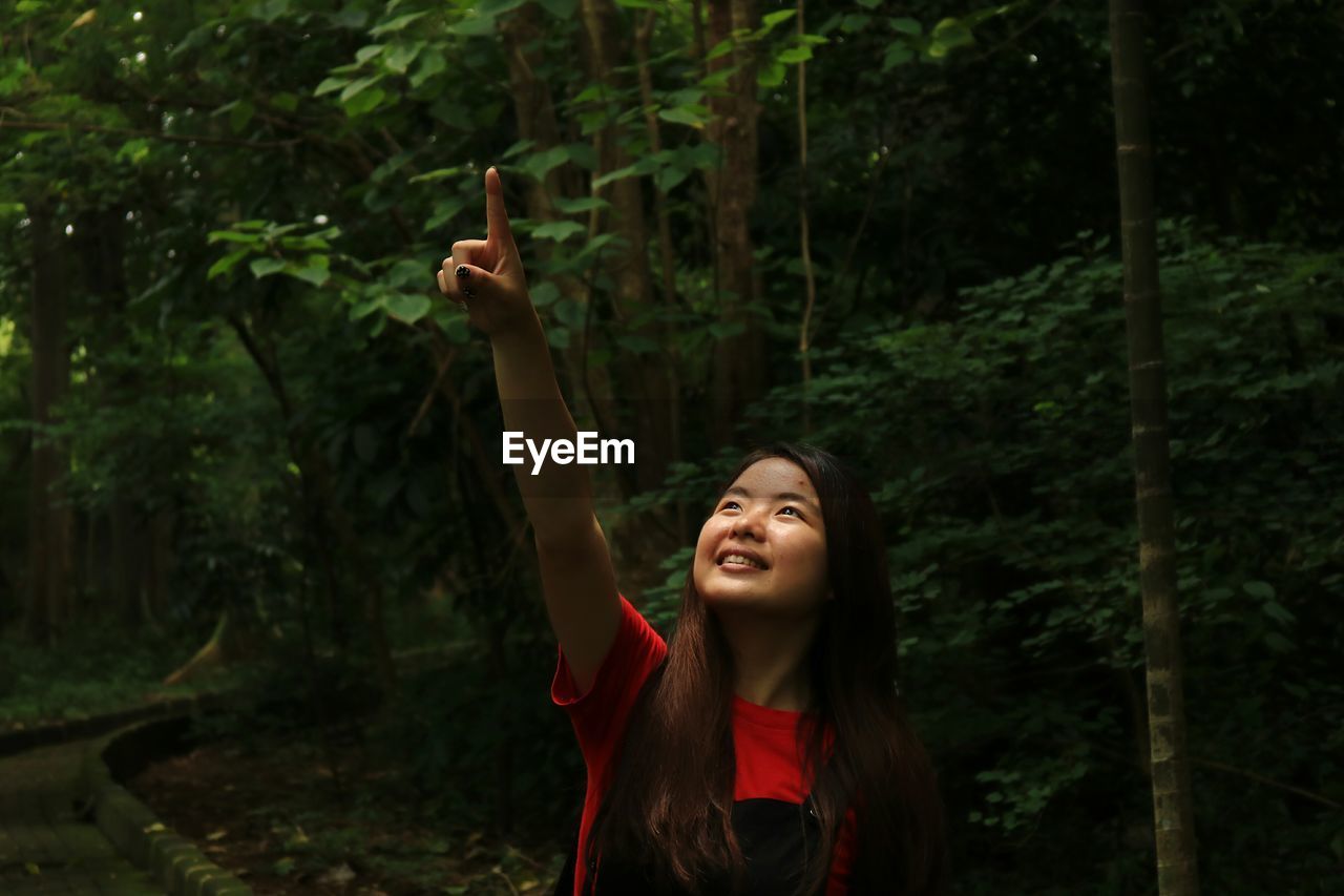 Woman standing at forest