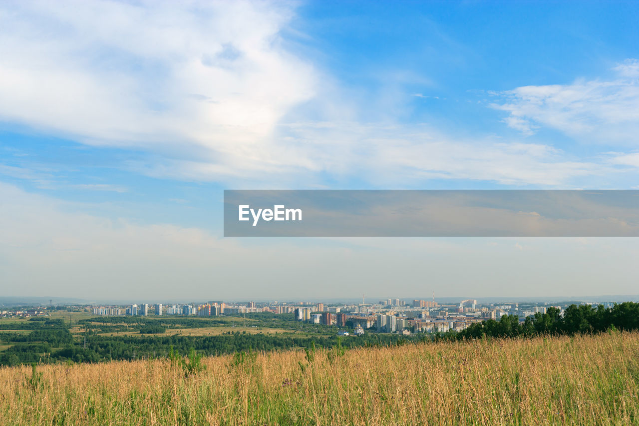 SCENIC VIEW OF GRASSY FIELD AGAINST SKY