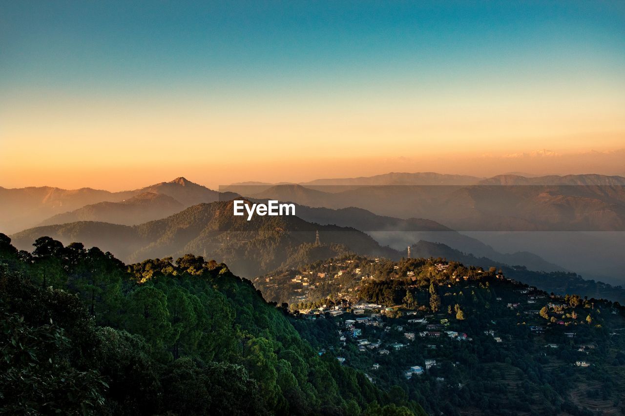 Scenic view of mountains against sky during sunset.