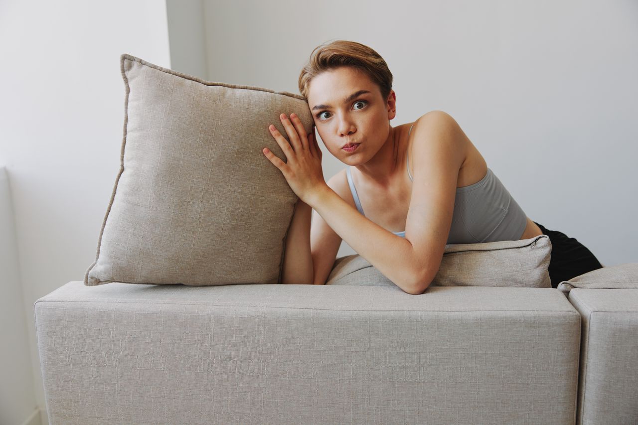 portrait of woman sitting on sofa at home