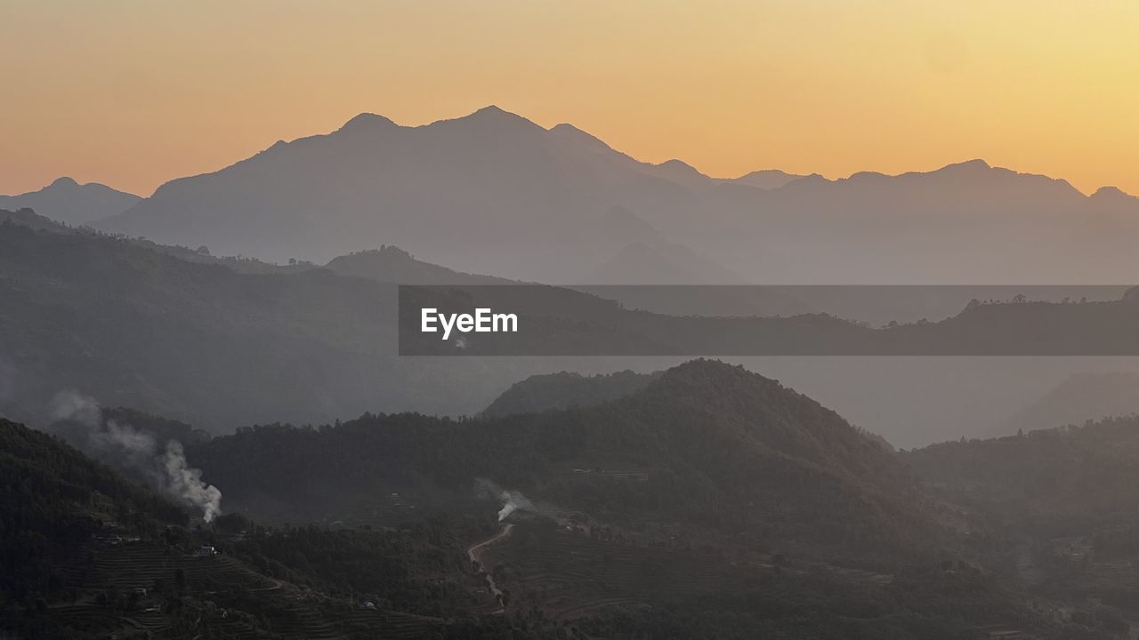 mountain, environment, landscape, scenics - nature, mountain range, sky, fog, beauty in nature, land, nature, sunset, travel, dawn, sun, mountain peak, tranquility, travel destinations, twilight, no people, outdoors, wilderness, tourism, valley, mist, silhouette, forest, tranquil scene, ridge, summit, panoramic, tree, sunlight, plant, non-urban scene, plateau, activity, vacation, trip, holiday, rural scene