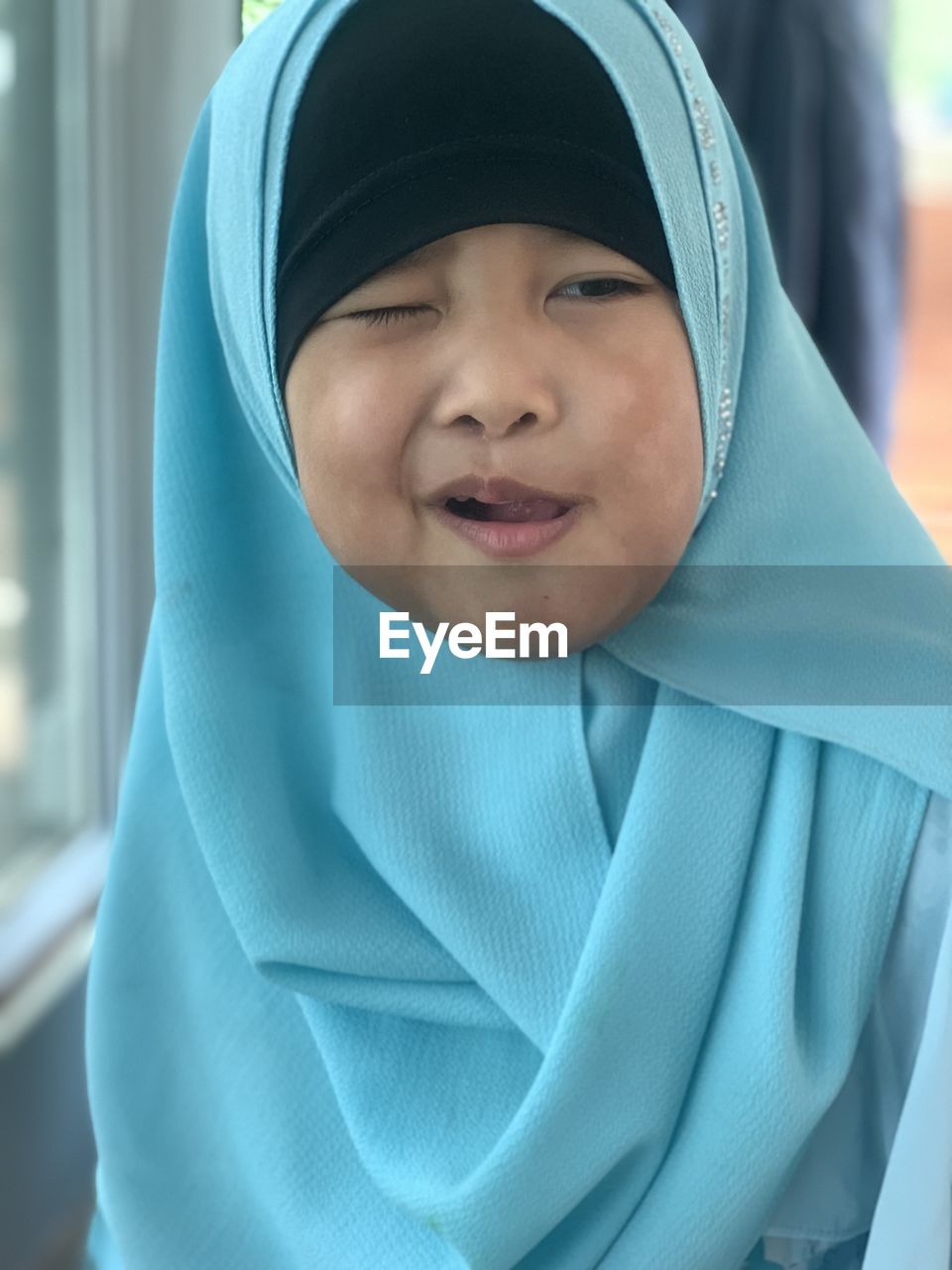 portrait, hijab, blue, child, childhood, one person, hood, hood - clothing, headscarf, looking at camera, headshot, clothing, person, emotion, men, baby, front view, hooded shirt, smiling, female, happiness, close-up, day