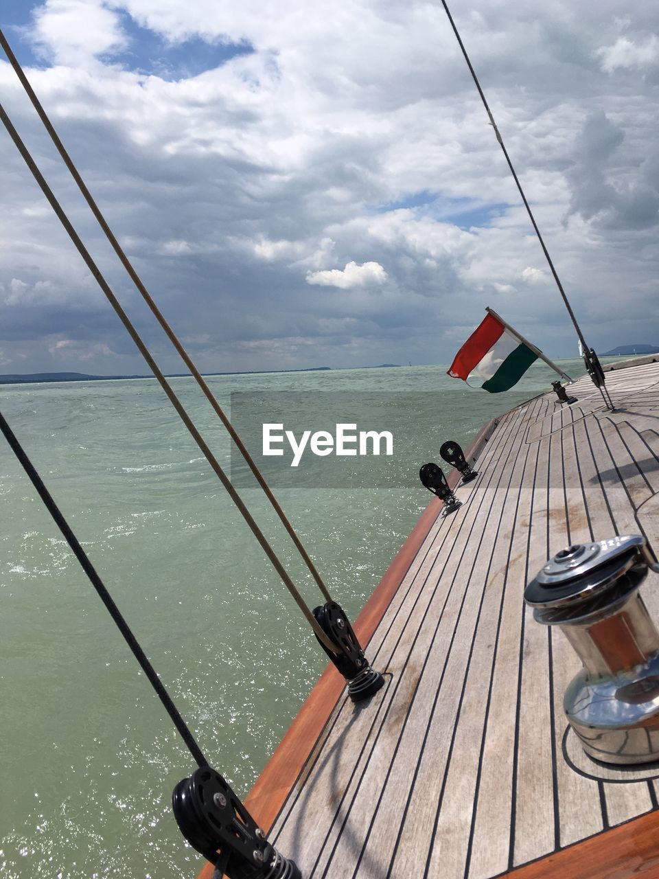 BOATS IN SEA AGAINST CLOUDY SKY