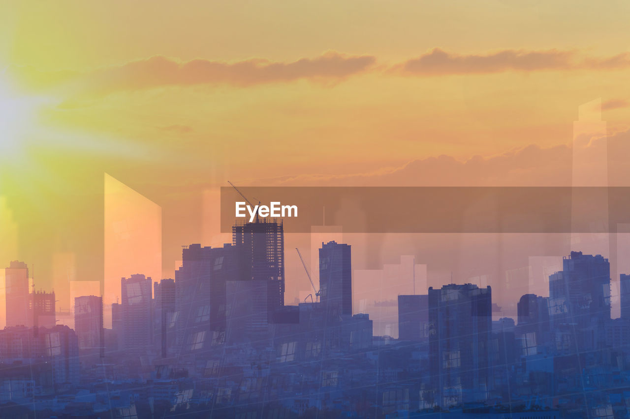 Buildings in city during sunset